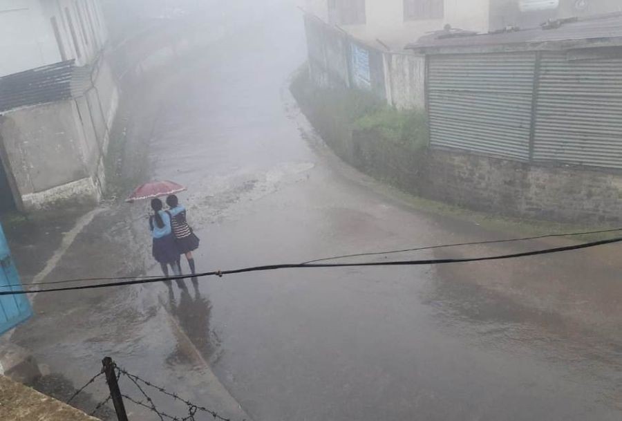 Two students brave the rains in Nagaland. The NSDMA has forecast rainfall across the state from July 9 to 12. (Morung File Photo)